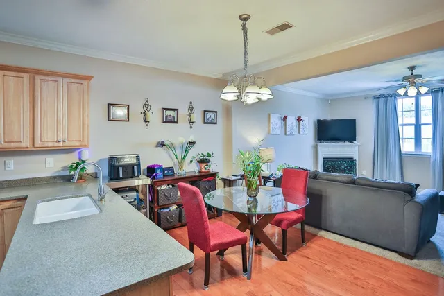 a view of a dining room with furniture and chandelier