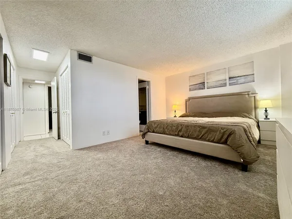 a bedroom with a bed and a night stand