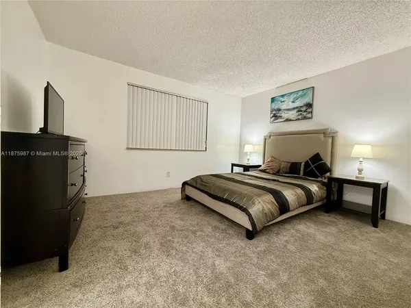 a bedroom with a bed and a fireplace