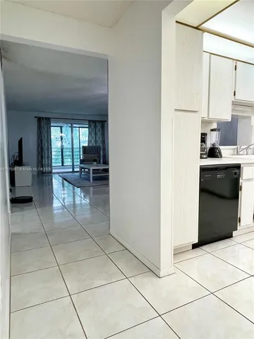 a kitchen with stainless steel appliances a stove a sink and a refrigerator