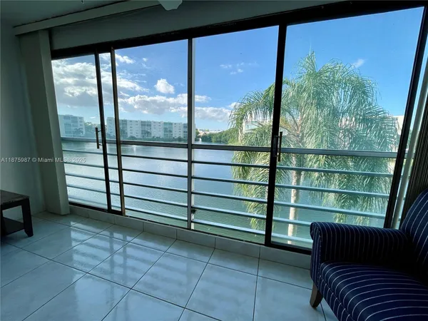 a view of a room with furniture and a balcony