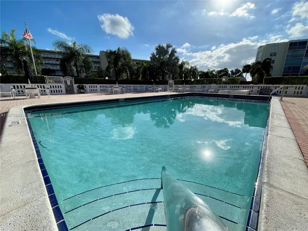 a view of a swimming pool with a yard
