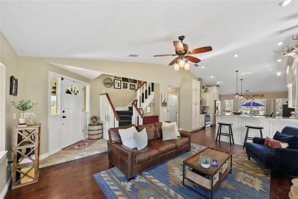 a dining room with furniture a rug and wooden floor