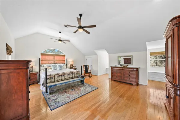 a dining room with wooden floor table and chairs