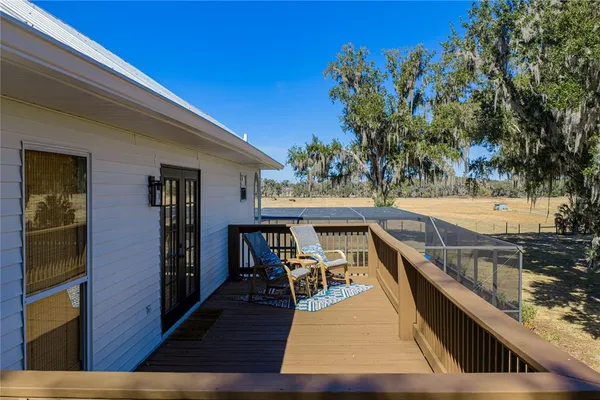 a view of a yard with wooden fence