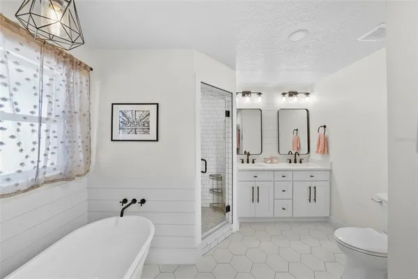 a backyard of a house with barbeque oven and outdoor seating