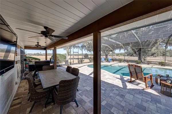 a view of a house with a tree next to a yard
