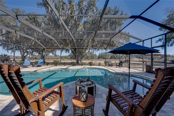 a living room with furniture a rug and white walls