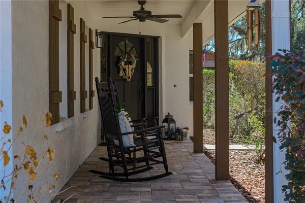 a living room with furniture a ceiling fan and a rug