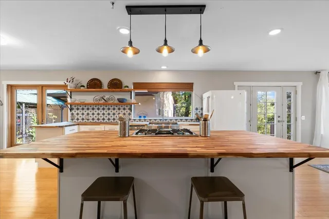 a bathroom with a double vanity sink a mirror and a bathtub