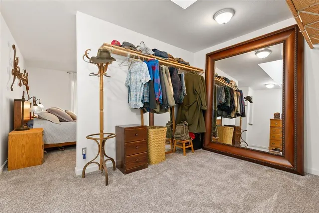 a dining room with glass windows table and chairs
