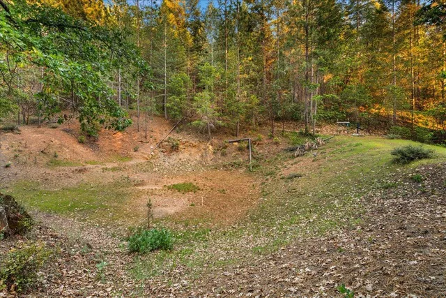 a kitchen with stainless steel appliances granite countertop a sink and wooden cabinets