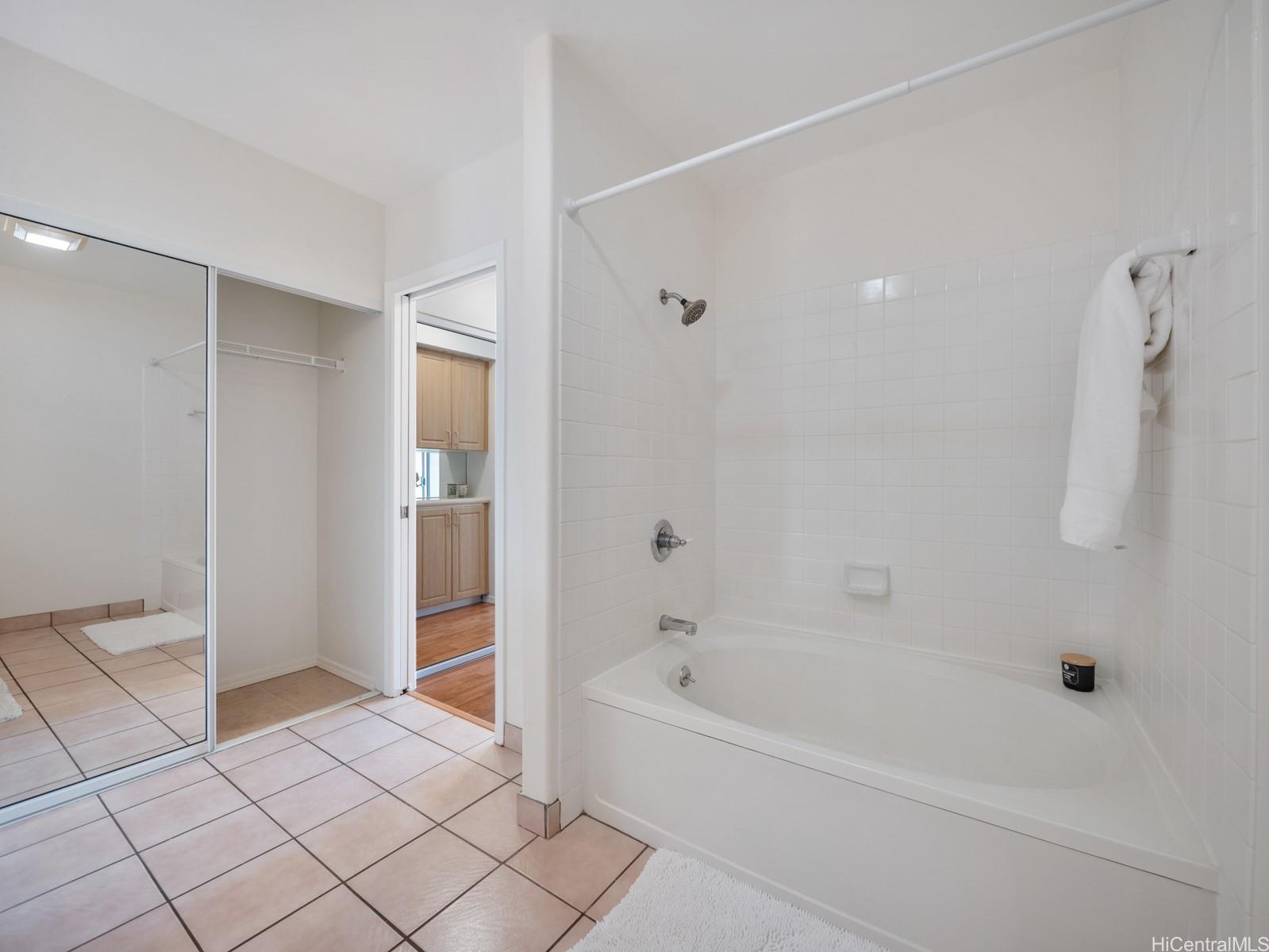 95-982 Wikao Street, Unit L203 Mililani, HI 96789 - Photo 14 of 25 a bathroom with a bathtub and a shower