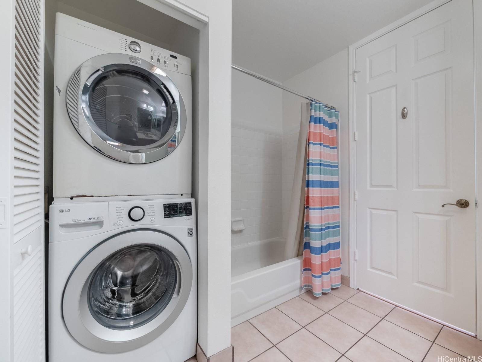 95-982 Wikao Street, Unit L203 Mililani, HI 96789 - Photo 19 of 25 a view of a hallway with washer and dryer