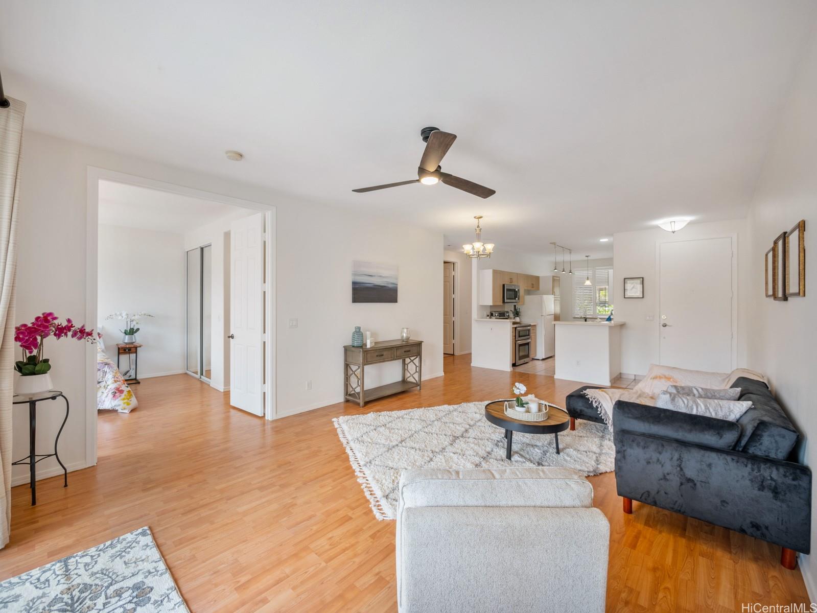 95-982 Wikao Street, Unit L203 Mililani, HI 96789 - Photo 2 of 25 a living room with furniture and kitchen view
