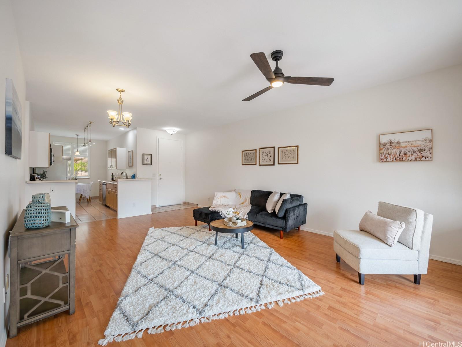 95-982 Wikao Street, Unit L203 Mililani, HI 96789 - Photo 3 of 25 a living room with furniture and a chandelier