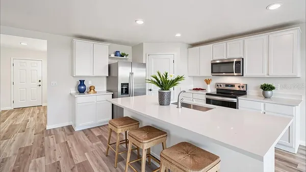 a kitchen with a table and chairs in it