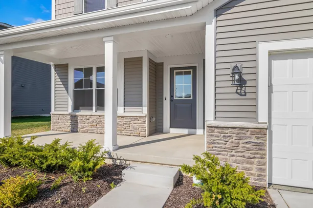 front view of a brick house with a large window