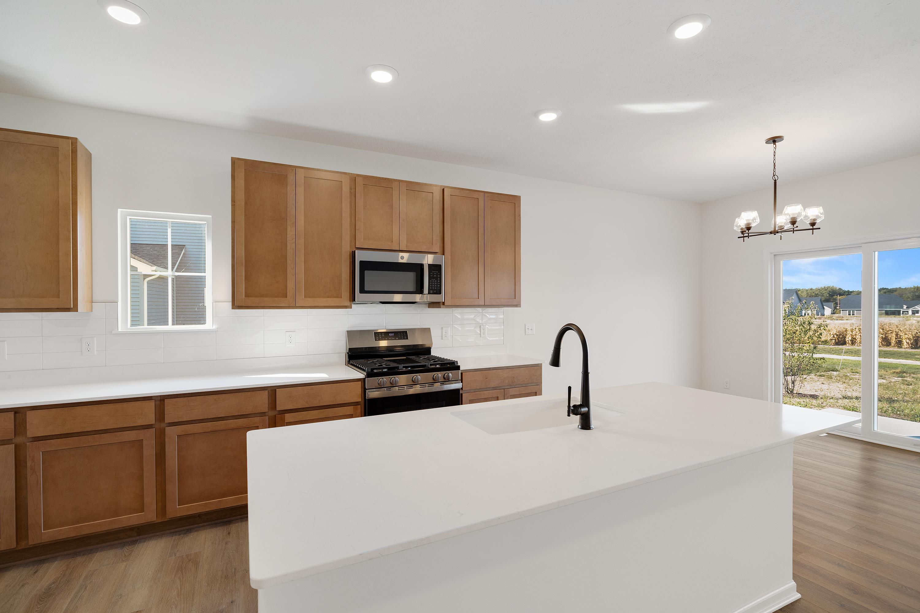 3980 Riverwood Road Valparaiso, IN 46385 - Photo 7 of 28 a kitchen with sink a microwave and cabinets