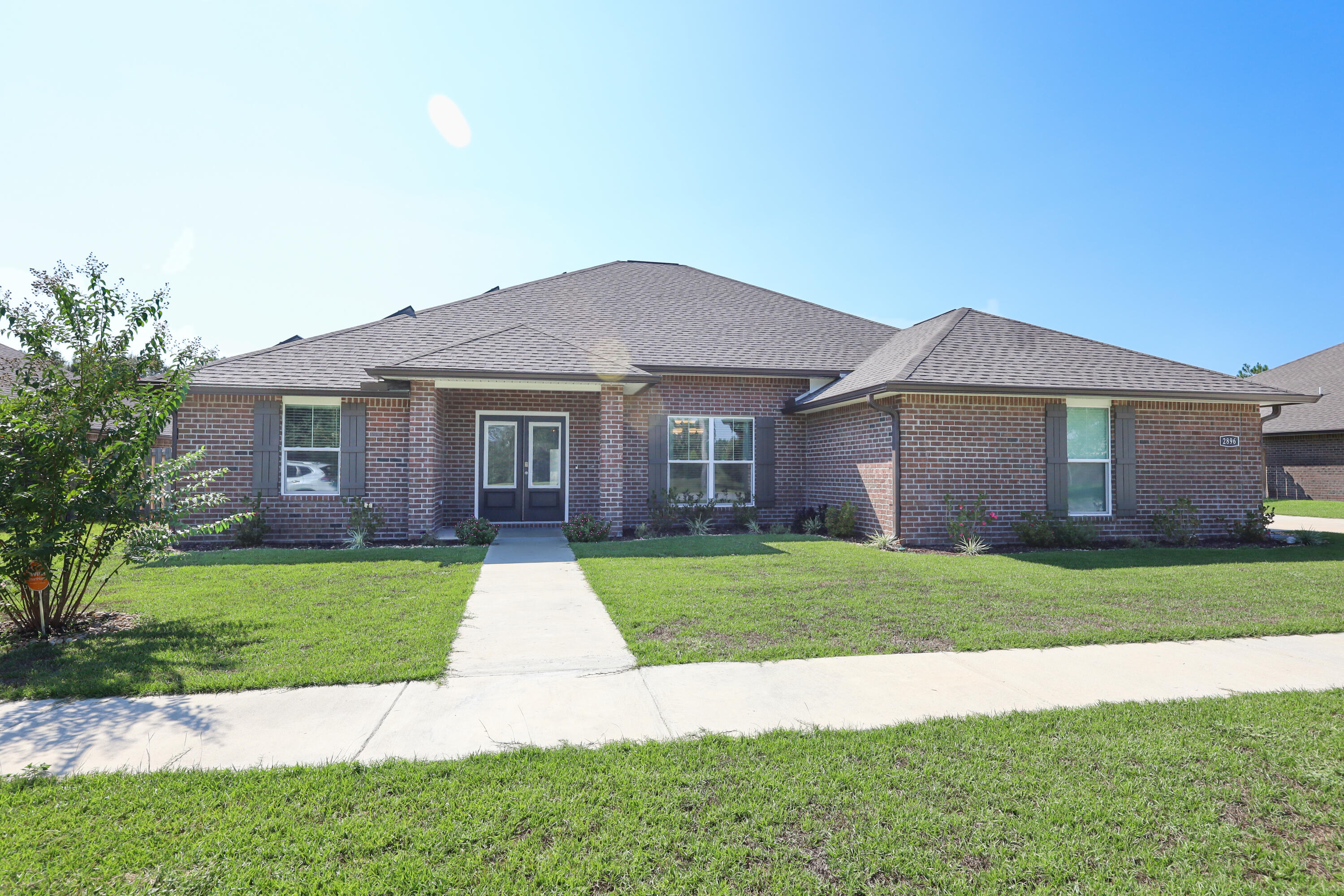 2896 Chancery Lane Crestview, FL 32539 - Photo 1 of 33 a front view of a house with a yard and garage