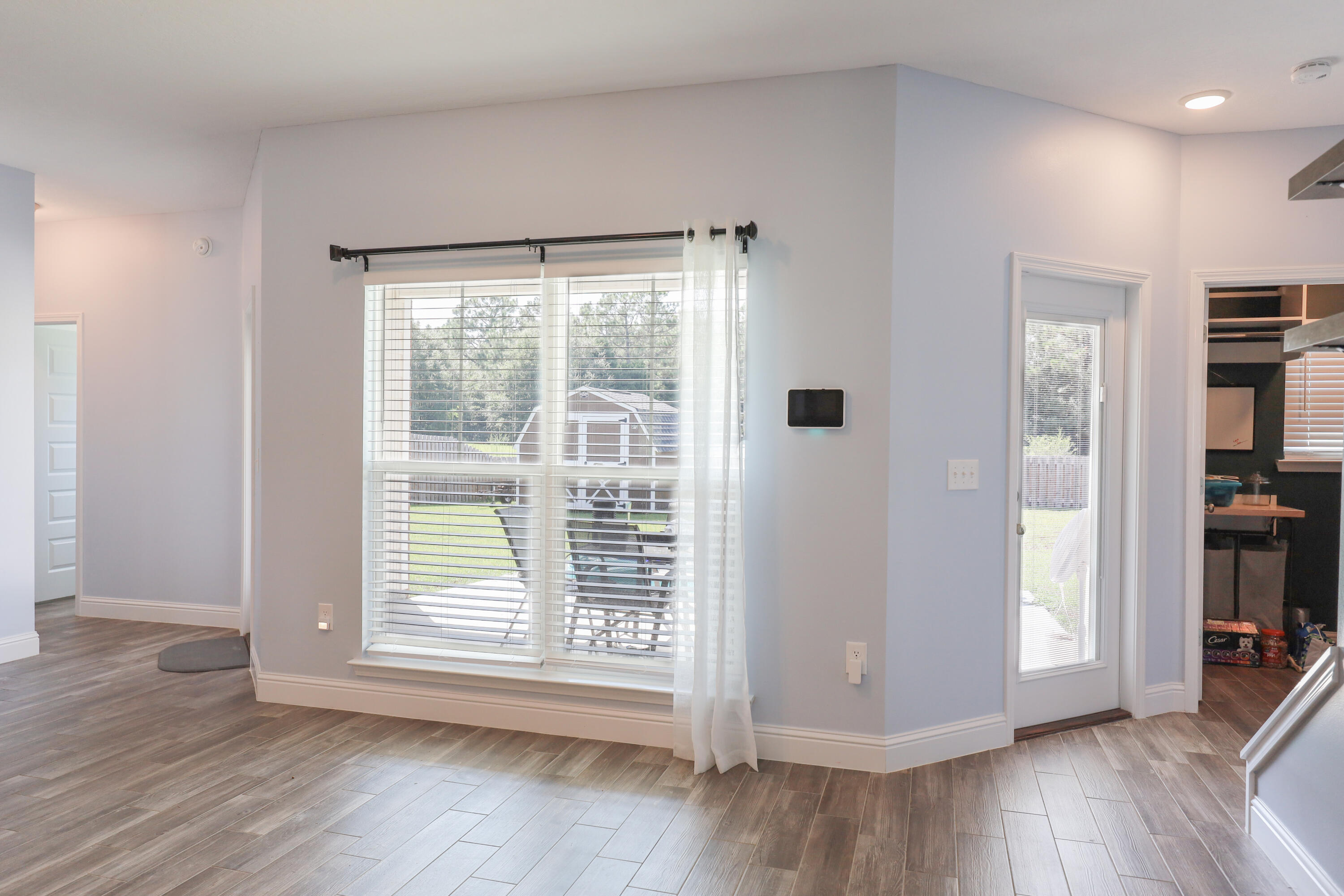 2896 Chancery Lane Crestview, FL 32539 - Photo 11 of 33 a view of an empty room with wooden floor and a window