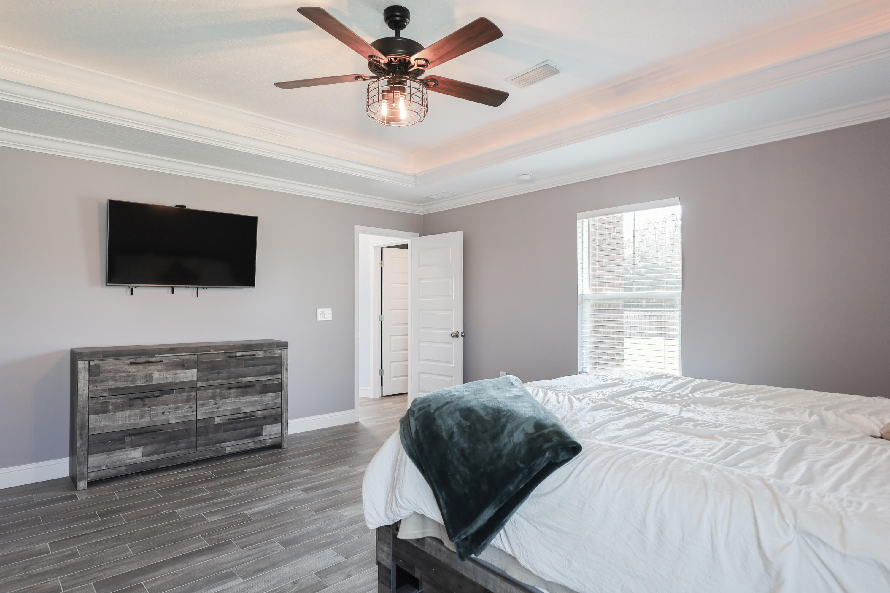 2896 Chancery Lane Crestview, FL 32539 - Photo 14 of 33 a bedroom with a bed a flat screen tv and a dresser