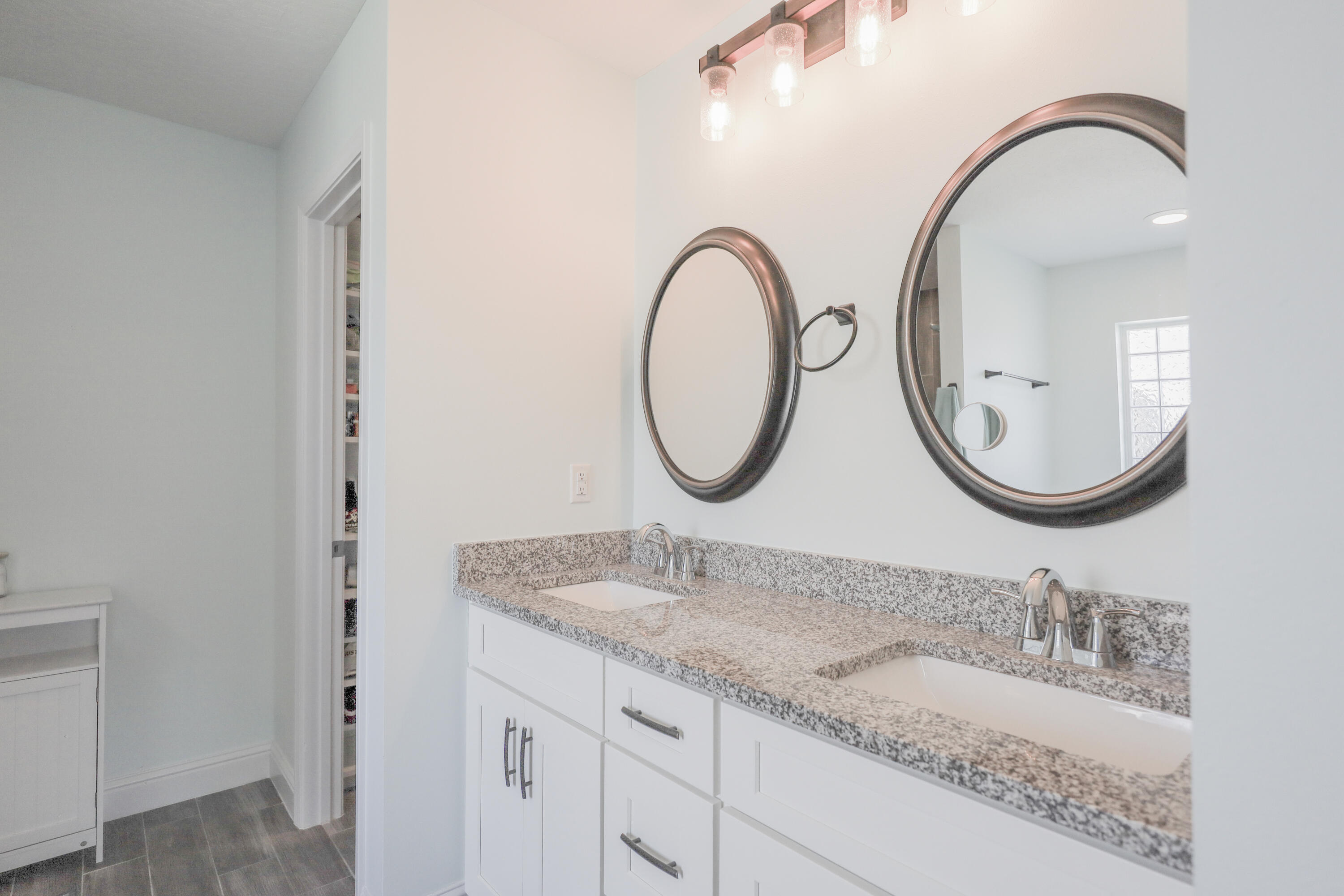 2896 Chancery Lane Crestview, FL 32539 - Photo 15 of 33 a bathroom with a granite countertop double vanity sink and a mirror