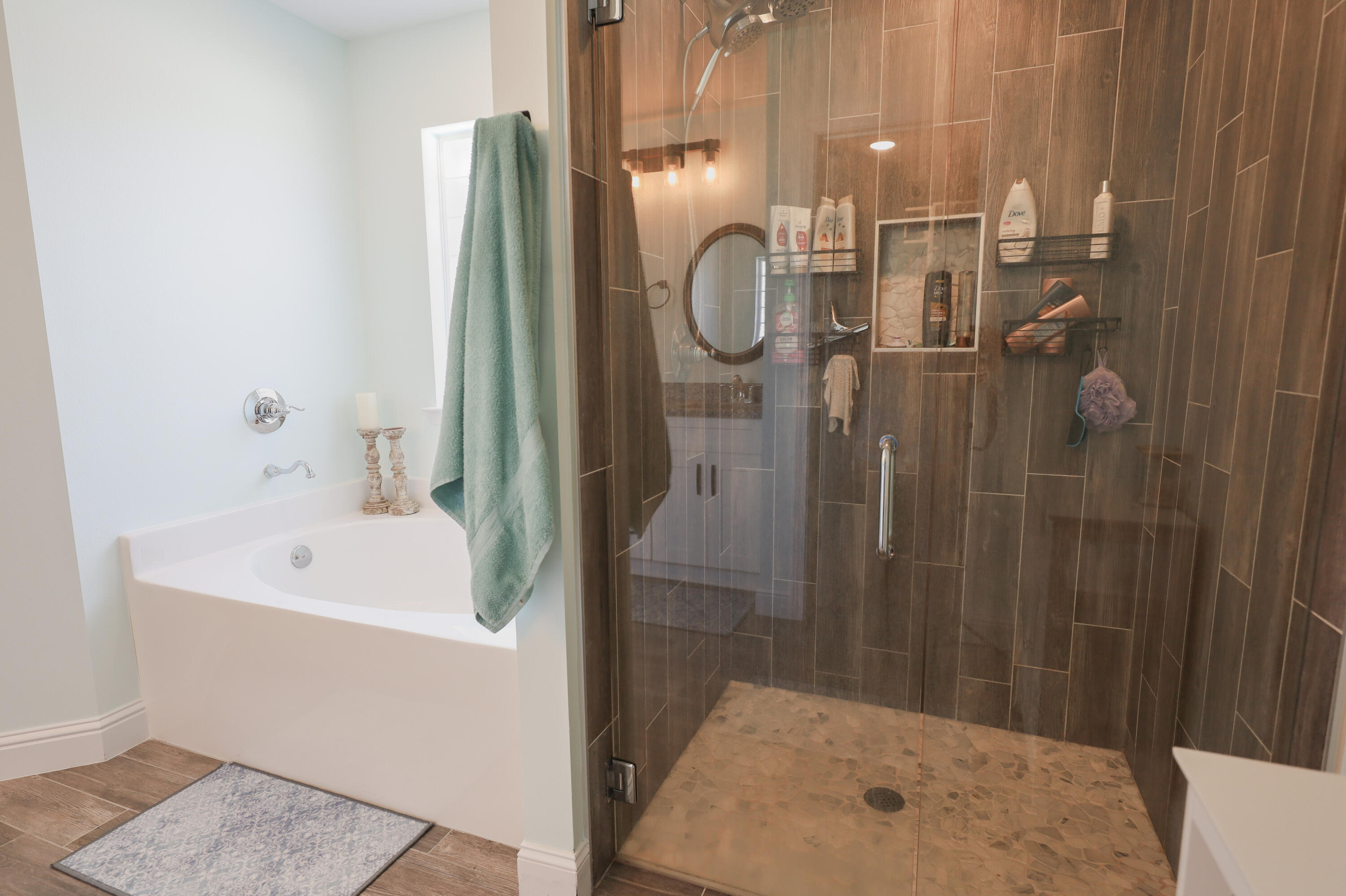 2896 Chancery Lane Crestview, FL 32539 - Photo 16 of 33 a bathroom with a sink a mirror and shower