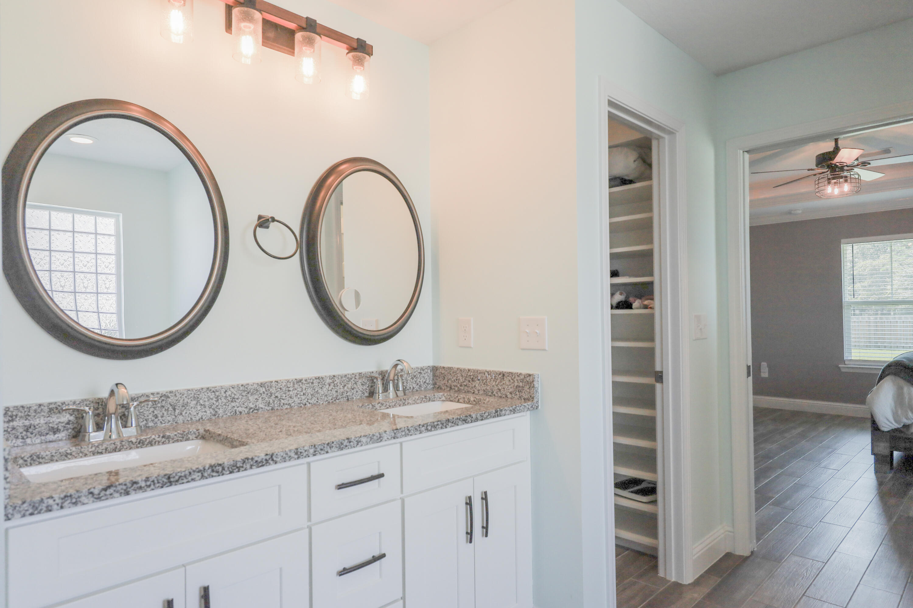 2896 Chancery Lane Crestview, FL 32539 - Photo 17 of 33 a bathroom with a granite countertop double vanity sink and a mirror