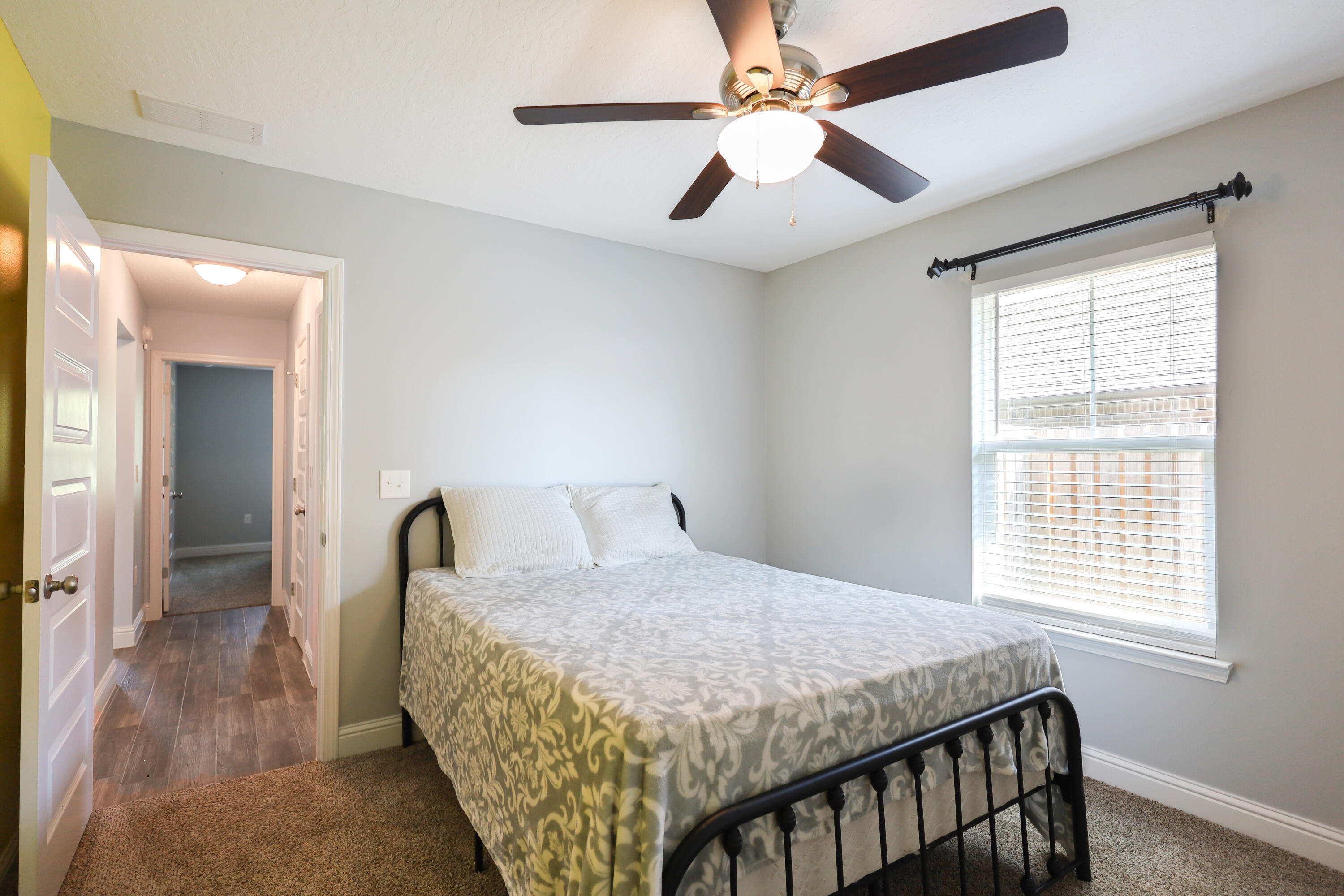 2896 Chancery Lane Crestview, FL 32539 - Photo 19 of 33 a bedroom with a large bed and a chandelier
