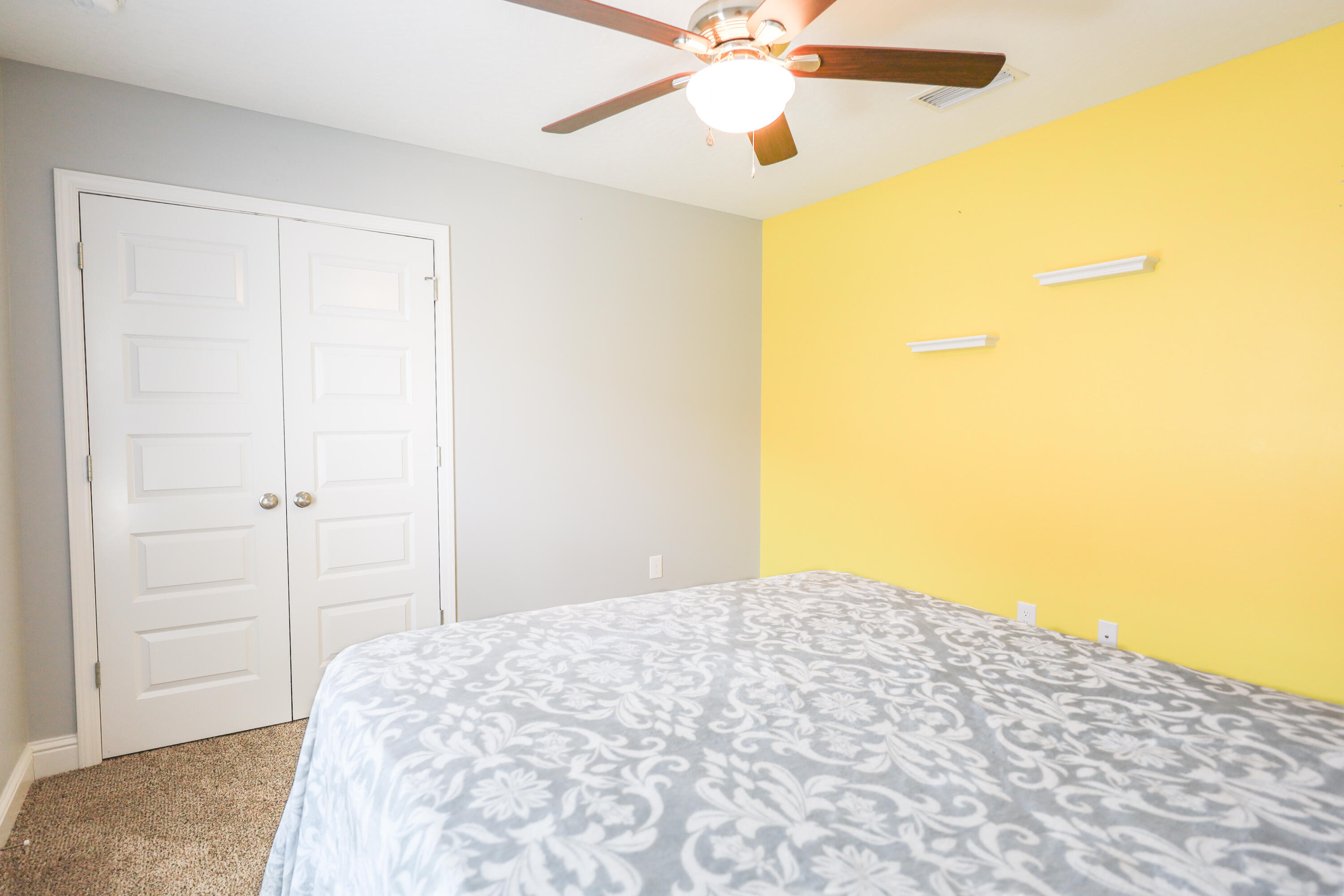2896 Chancery Lane Crestview, FL 32539 - Photo 20 of 33 a bedroom with a bed and a chandelier