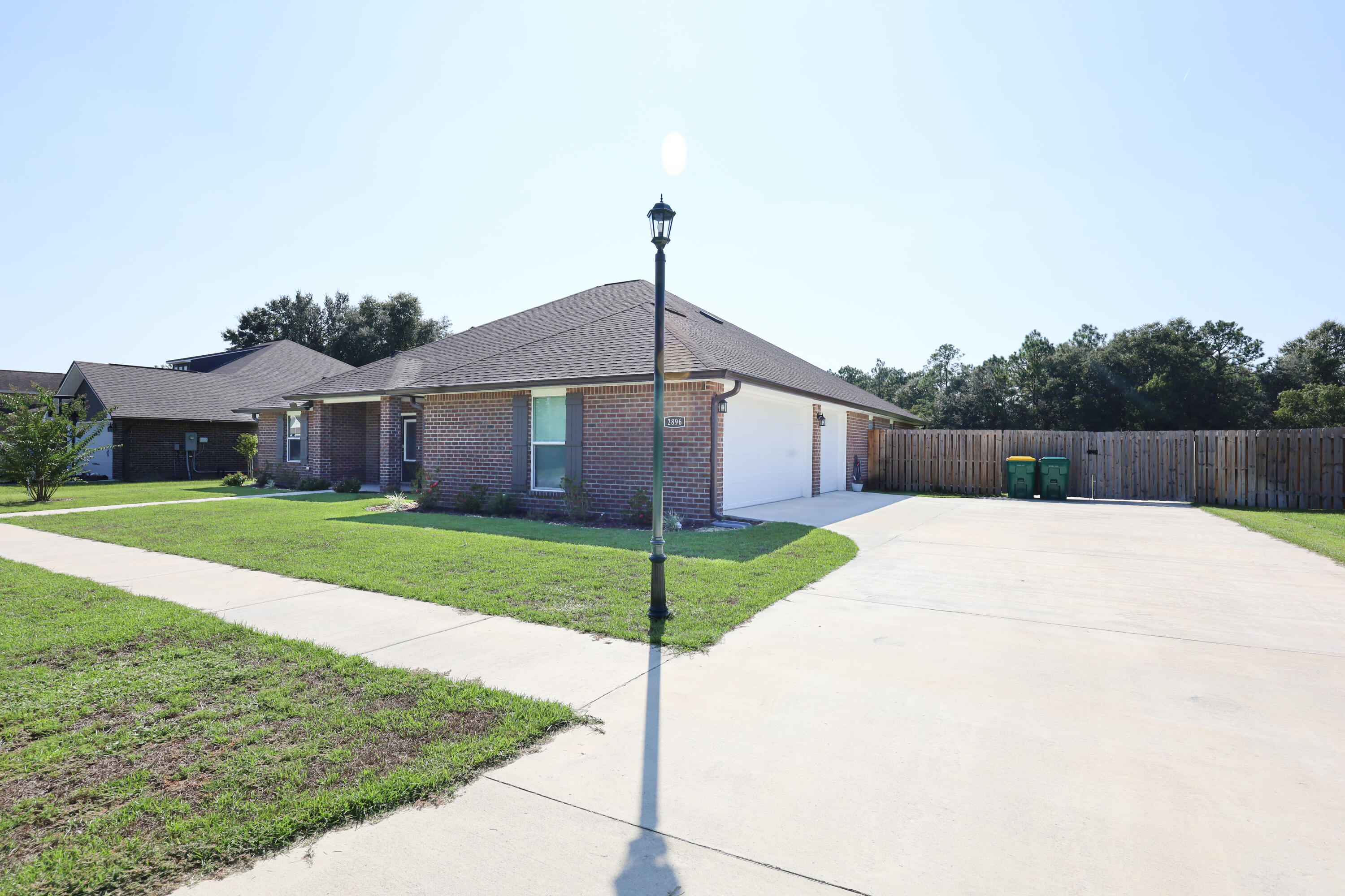2896 Chancery Lane Crestview, FL 32539 - Photo 2 of 33 a front view of a house with a yard