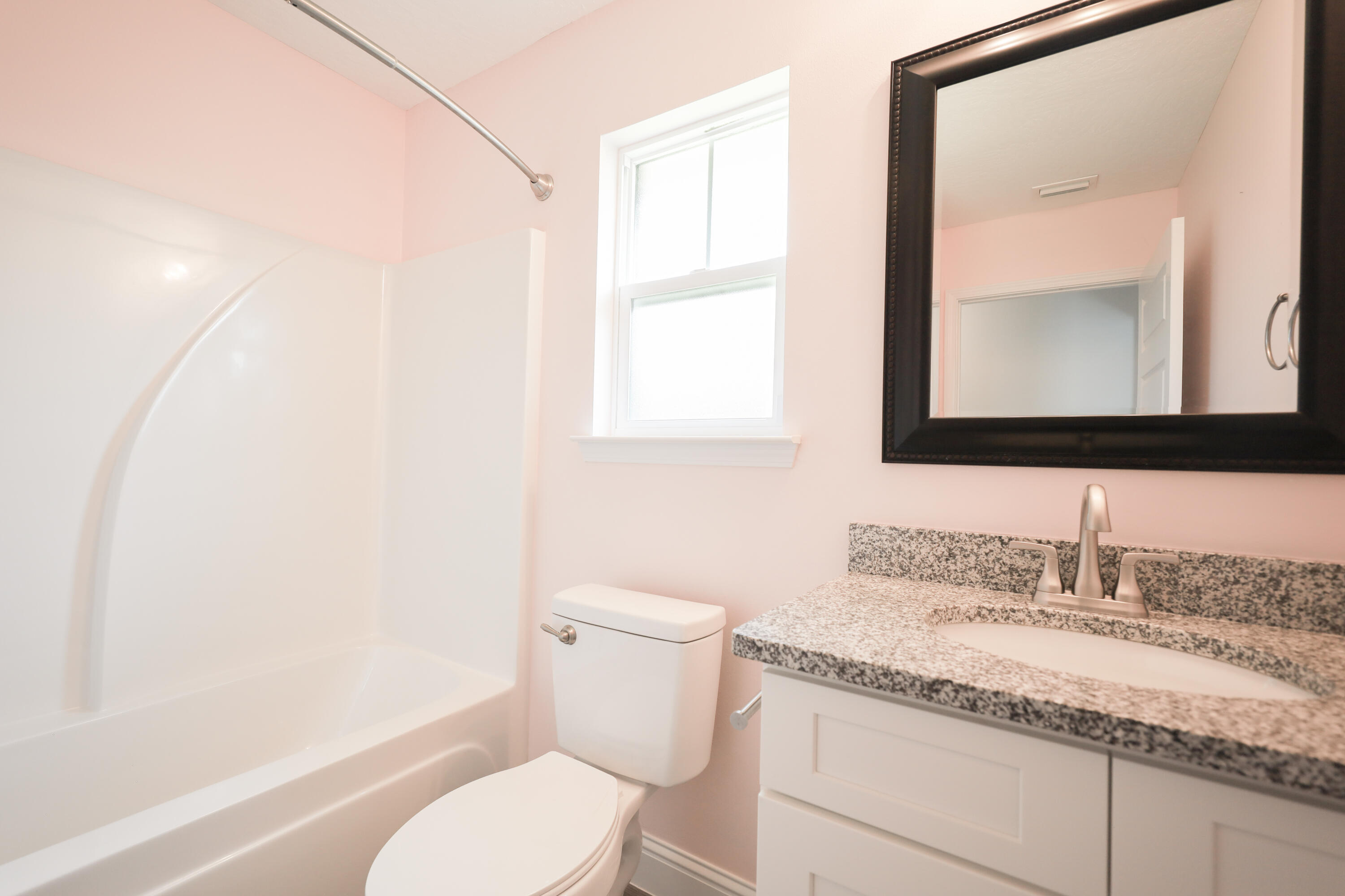 2896 Chancery Lane Crestview, FL 32539 - Photo 21 of 33 a bathroom with a granite countertop sink mirror vanity and toilet