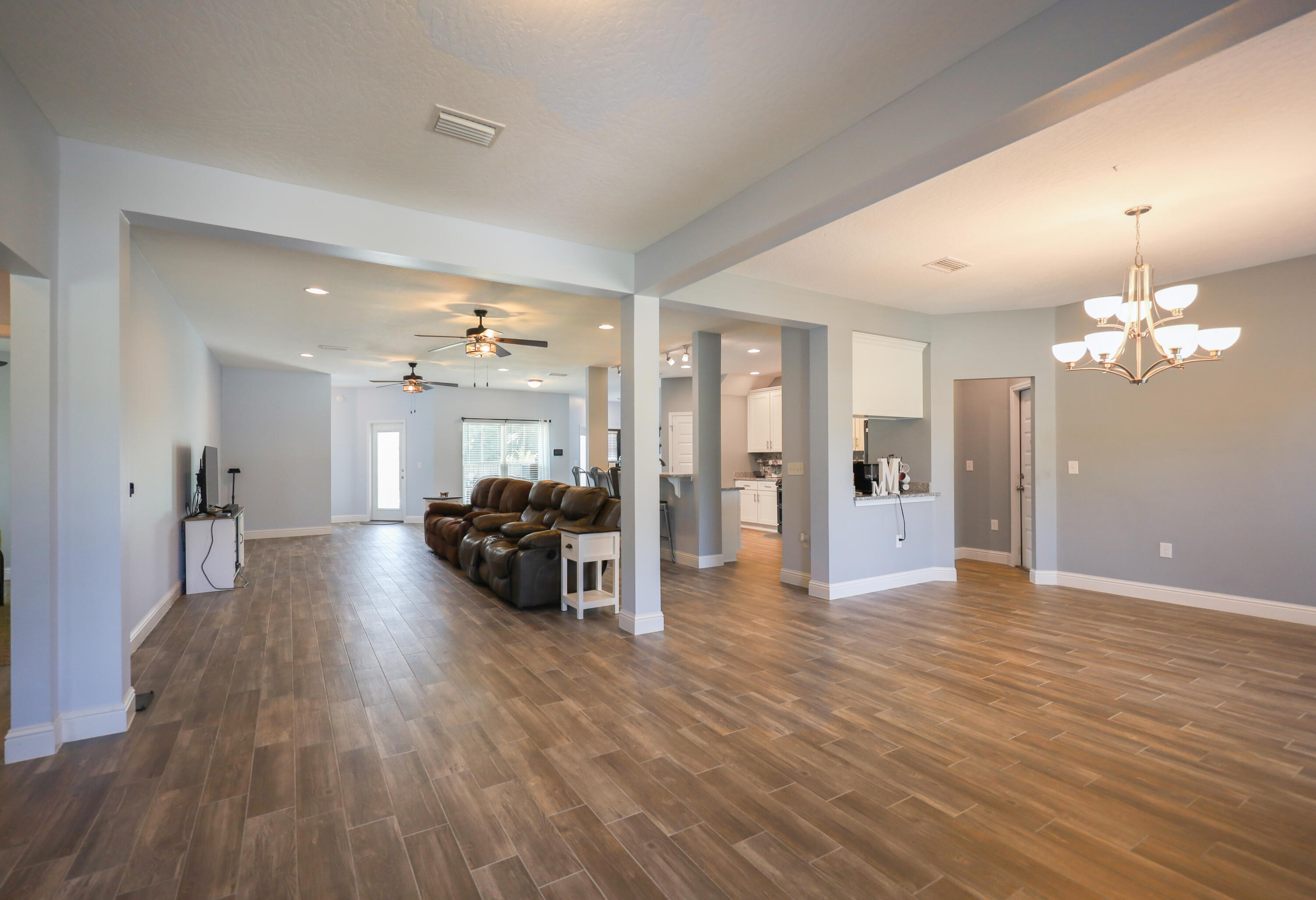 2896 Chancery Lane Crestview, FL 32539 - Photo 4 of 33 a view of a livingroom with furniture wooden floor and a chandelier