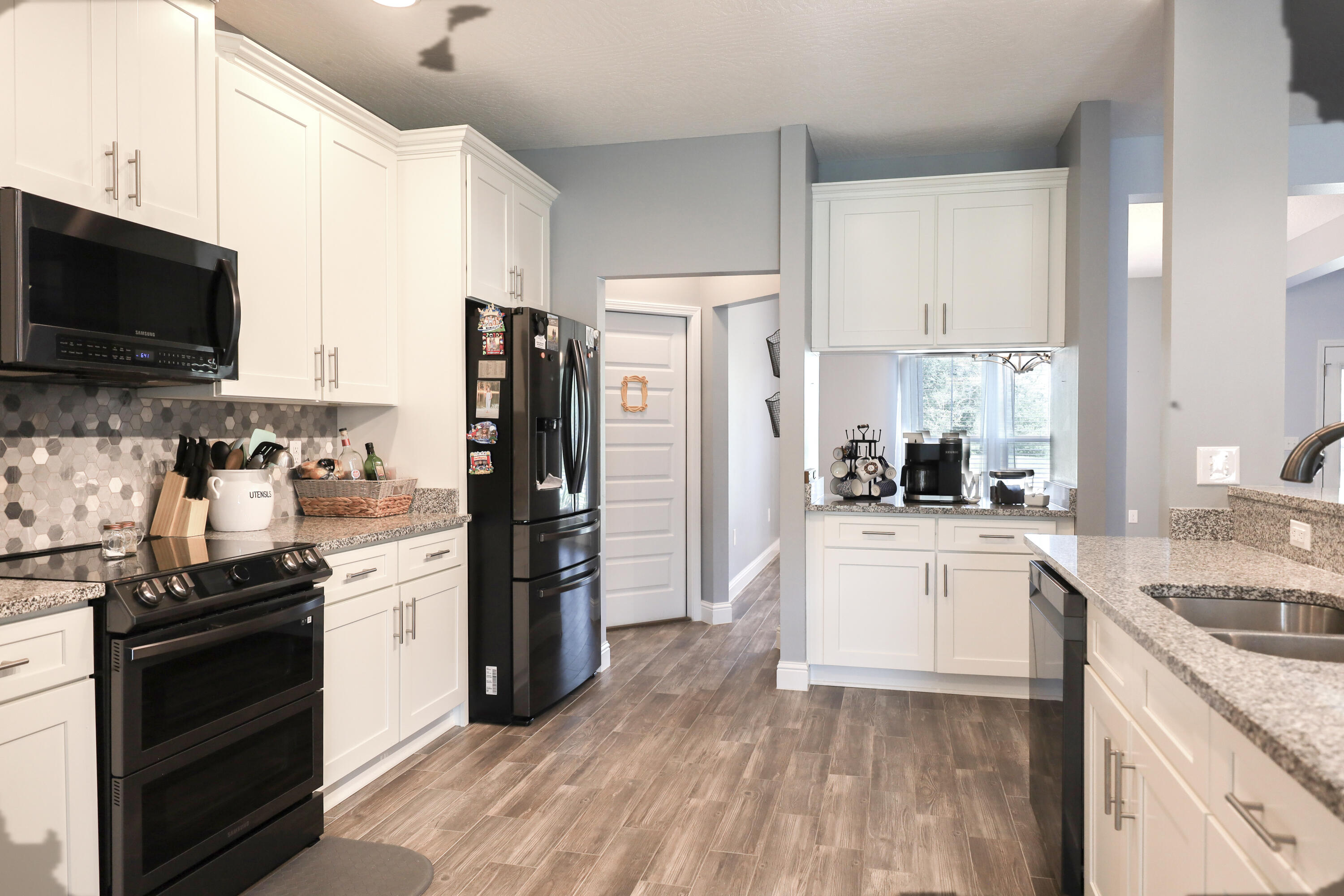 2896 Chancery Lane Crestview, FL 32539 - Photo 8 of 33 a kitchen with stainless steel appliances kitchen island granite countertop a refrigerator stove and sink