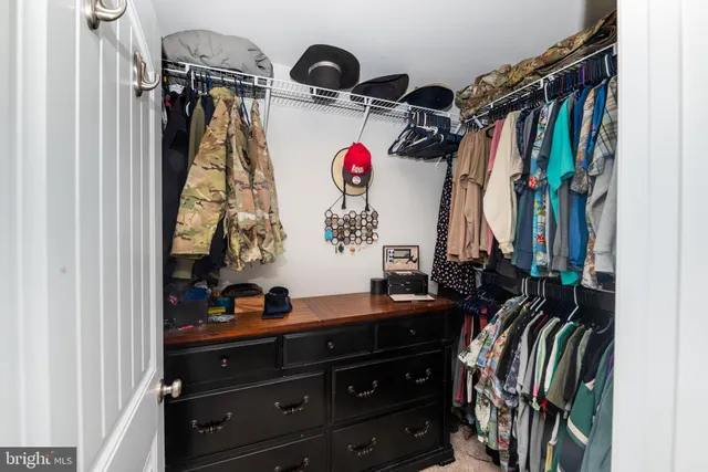 a bedroom with a bed and a wooden floor