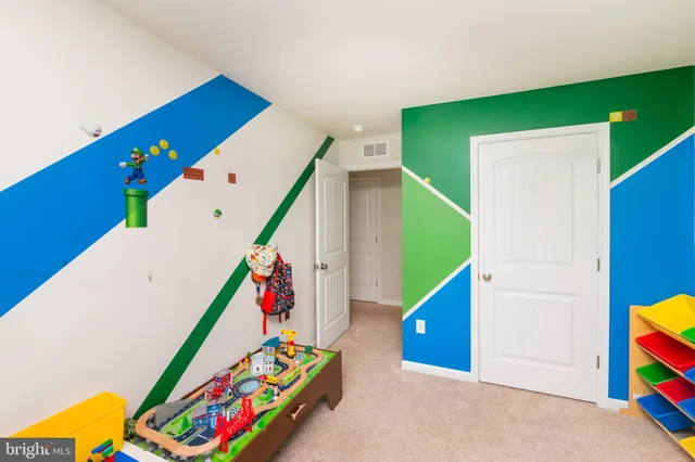 a bedroom with a bed and a book shelf