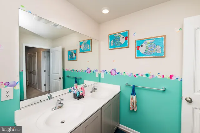 a bathroom with a sink toilet and a mirror