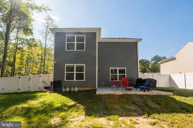a front view of house with a garden