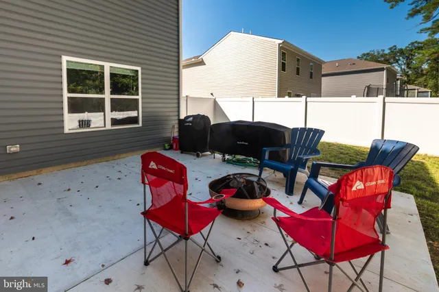 a view of yard with swimming pool and trees in the background