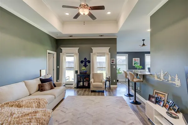 a living room with furniture and wooden floor