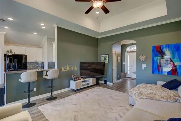 a bedroom with furniture and a flat screen tv
