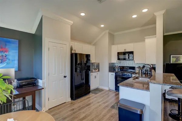 a kitchen with stainless steel appliances a refrigerator and a stove top oven