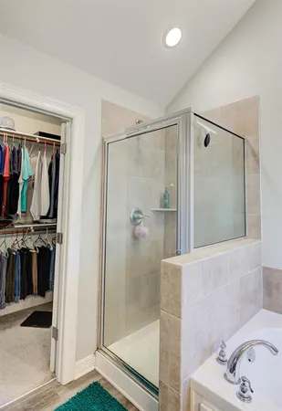 a bathroom with a bathtub and a shower