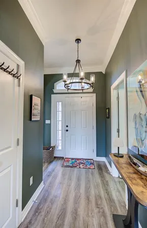 a view of a livingroom with wooden floor and hallway