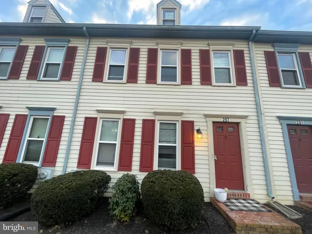 a view of a brick building next to a yard
