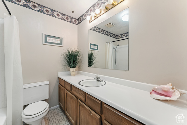 8843 Capernaum Road West Jordan, UT 84088 - Photo 16 of 31 Full bathroom featuring vanity and shower / bathtub combination with curtain