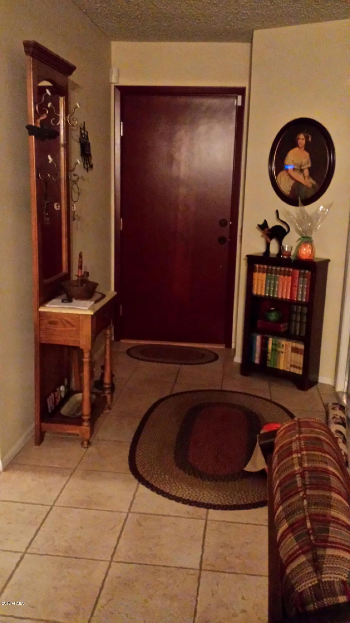 1738 East Grandview Road Phoenix, AZ 85022 - Photo 3 of 15 a room with furniture and a mirror