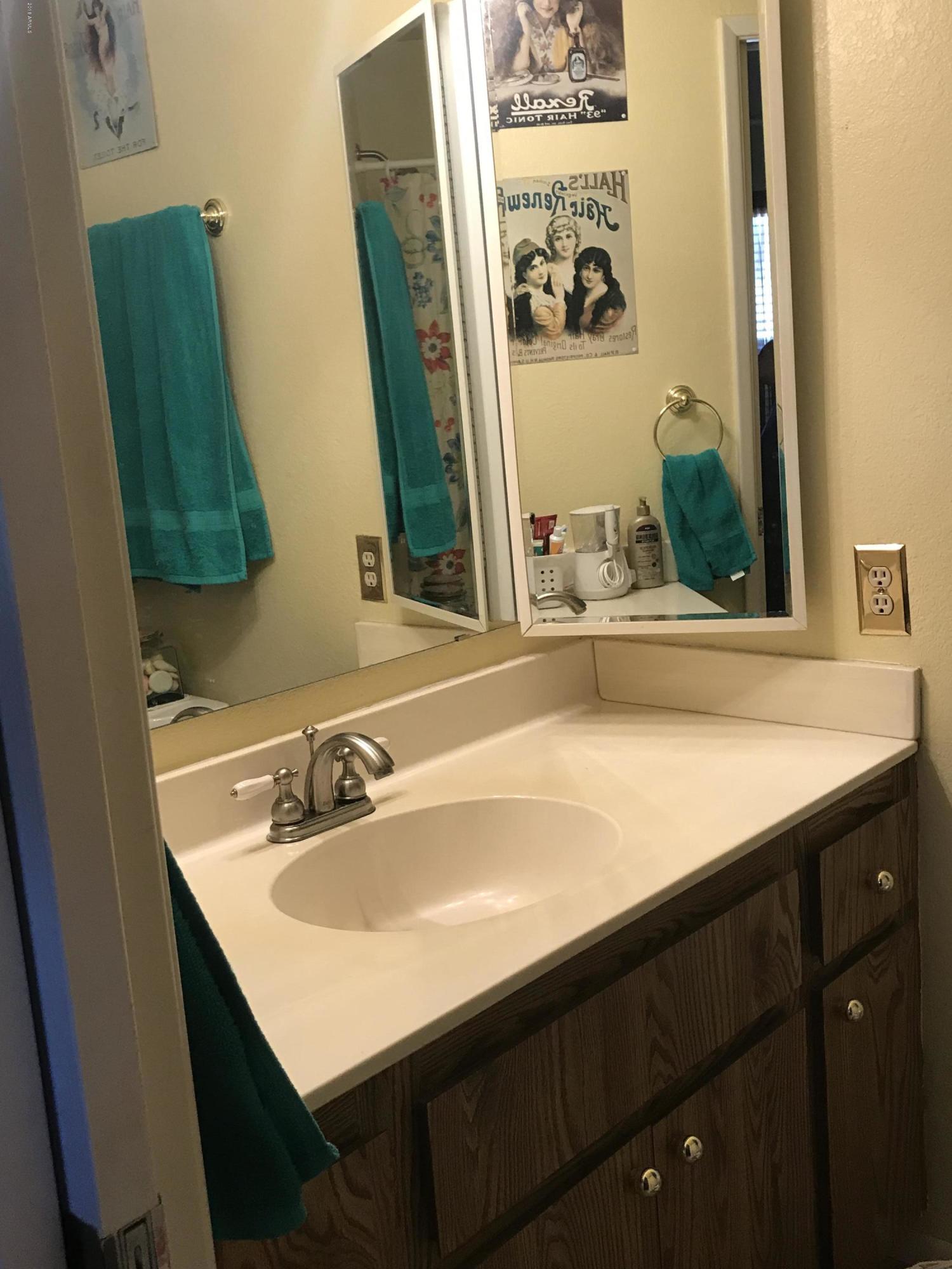 1738 East Grandview Road Phoenix, AZ 85022 - Photo 7 of 15 a bathroom with a sink and a mirror