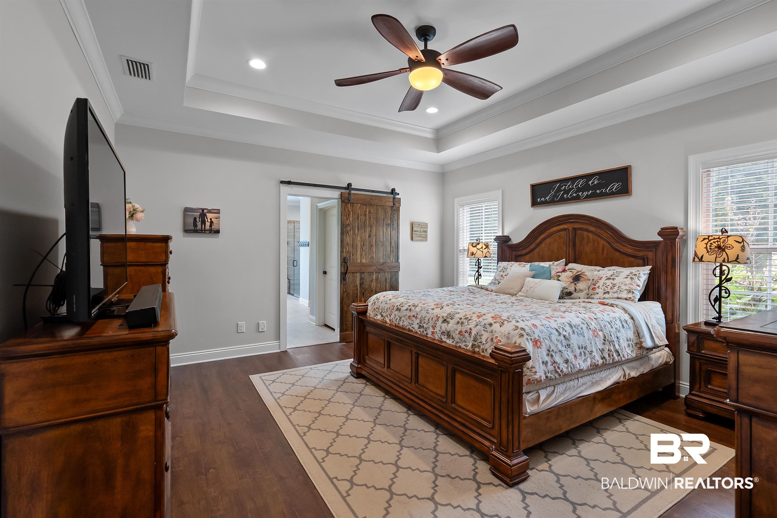 12070 Comalander Road Fairhope, AL 36532 - Photo 18 of 50 Spacious bedroom featuring a tray ceiling with a ceiling fan, recessed lighting, and wood-finish flooring
